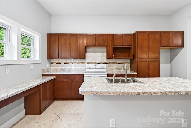 4 Stars Forever Dr, Black Mountain, NC 28711 - kitchen with white range with electric stovetop, light countertops, backsplash, light tile patterned floors, and brown cabinets