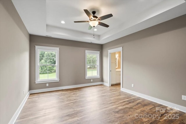 18 Morningside Dr, Granite Falls, NC 28630 - empty room featuring healthy amount of natural light, a raised ceiling, light wood-type flooring, and recessed lighting