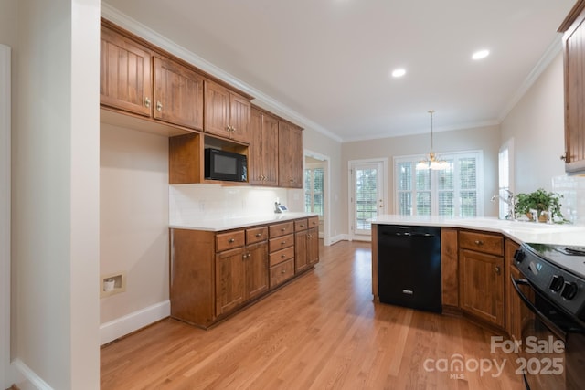 1503 Jack White Dr, Rock Hill, SC 29732 - kitchen featuring black appliances, brown cabinetry, light wood-type flooring, a chandelier, and crown molding