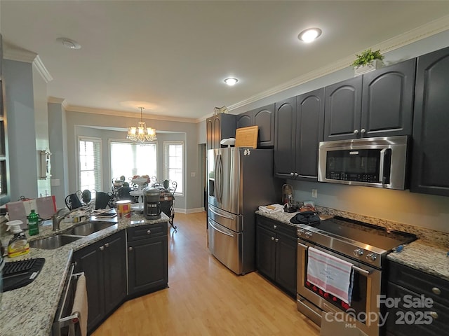 509 E Main St, Rockwell, NC 28138 - kitchen featuring stainless steel appliances, a chandelier, light stone countertops, light wood-style floors, and ornamental molding
