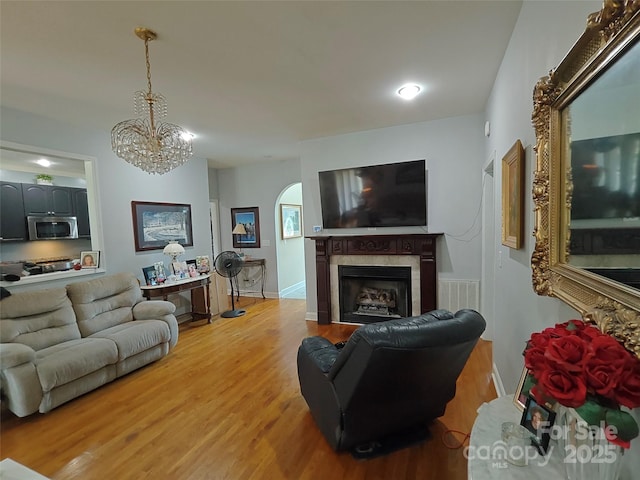 509 E Main St, Rockwell, NC 28138 - living area featuring light wood finished floors, a fireplace, and a chandelier