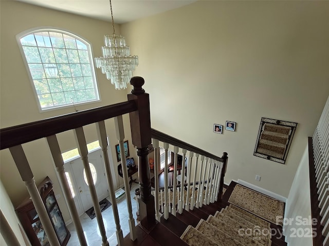 509 E Main St, Rockwell, NC 28138 - staircase with a chandelier, a towering ceiling, and wood finished floors