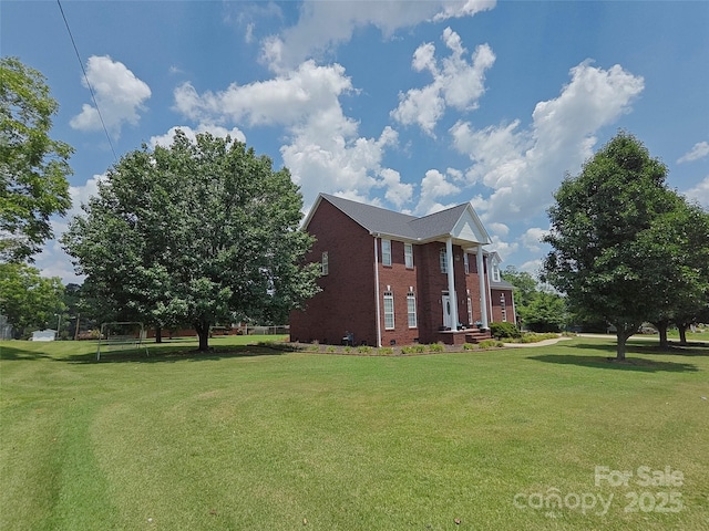 509 E Main St, Rockwell, NC 28138 - view of property exterior featuring brick siding and a yard