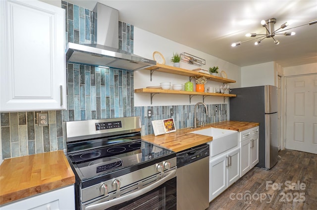 9325 Old Concord Rd Unit J, Charlotte, NC 28213 - kitchen with stainless steel appliances, wooden counters, wall chimney exhaust hood, and a chandelier