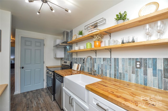 9325 Old Concord Rd Unit J, Charlotte, NC 28213 - kitchen with wall chimney range hood, appliances with stainless steel finishes, butcher block counters, backsplash, and dark wood-style flooring