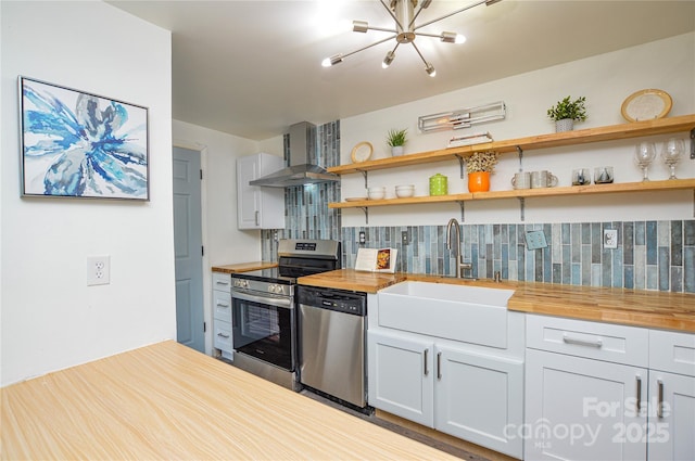 9325 Old Concord Rd Unit J, Charlotte, NC 28213 - kitchen featuring stainless steel appliances, wooden counters, wall chimney range hood, decorative backsplash, and a chandelier