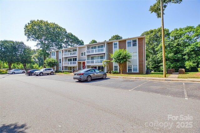 9325 Old Concord Rd Unit J, Charlotte, NC 28213 - view of building exterior featuring uncovered parking