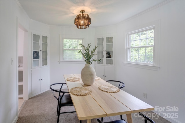 303 Odell St, Kannapolis, NC 28083 - dining area with light carpet, plenty of natural light, crown molding, and a chandelier