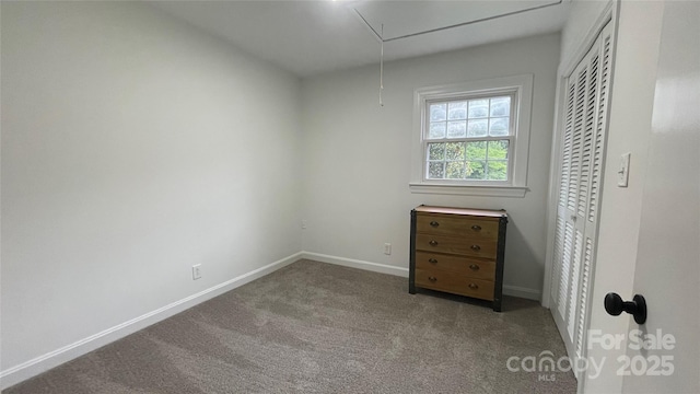 303 Odell St, Kannapolis, NC 28083 - unfurnished bedroom featuring attic access, carpet flooring, and a closet
