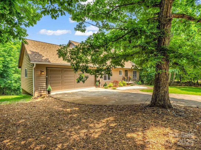 244 Timberlake Rd, Bostic, NC 28018 - view of front facade with concrete driveway, an attached garage, and roof with shingles