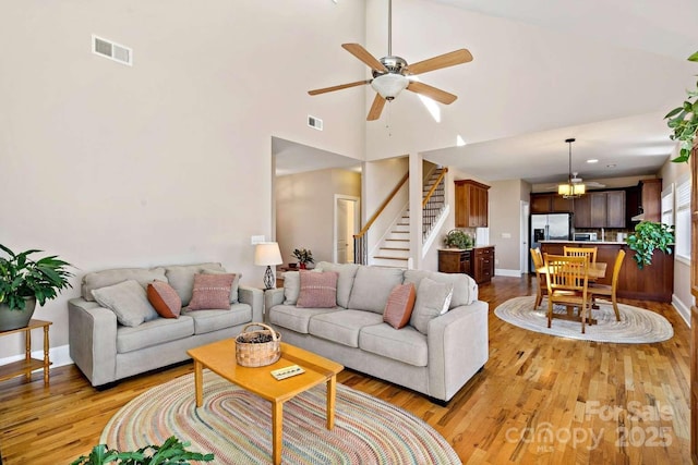 244 Timberlake Rd, Bostic, NC 28018 - living area featuring light wood-style floors, stairs, ceiling fan, and high vaulted ceiling