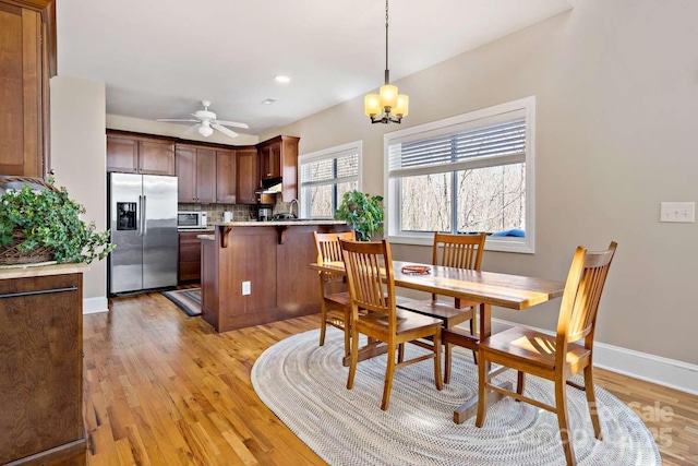 244 Timberlake Rd, Bostic, NC 28018 - dining area with light wood-style floors, a chandelier, and a ceiling fan