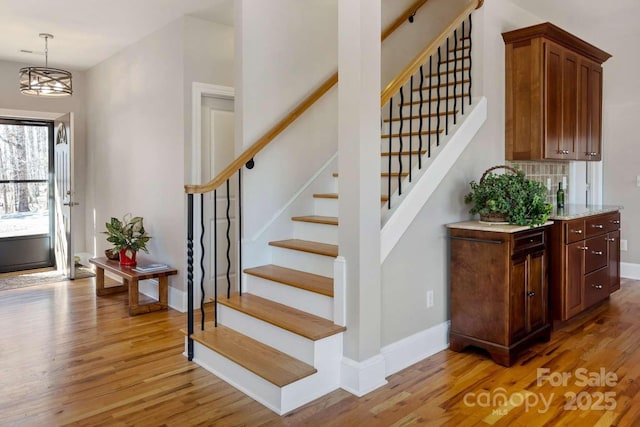 244 Timberlake Rd, Bostic, NC 28018 - foyer entrance with light wood-type flooring, stairway, and a chandelier