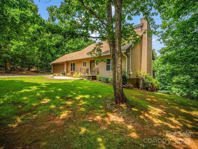 244 Timberlake Rd, Bostic, NC 28018 - view of front of property with a chimney, an attached garage, a front yard, and driveway