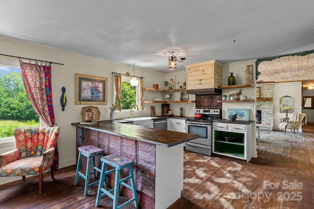 724 Teeter Rd, Mooresville, NC 28115 - kitchen featuring stainless steel appliances, open shelves, dark countertops, dark wood-type flooring, and a peninsula