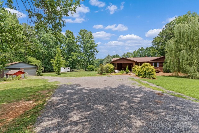 724 Teeter Rd, Mooresville, NC 28115 - single story home featuring driveway, a front lawn, a garage, and a storage unit