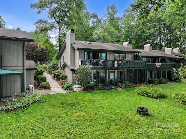 28 Toxaway Pt Unit B7, Lake Toxaway, NC 28747 - rear view of house with a chimney, a lawn, and an outdoor fire pit