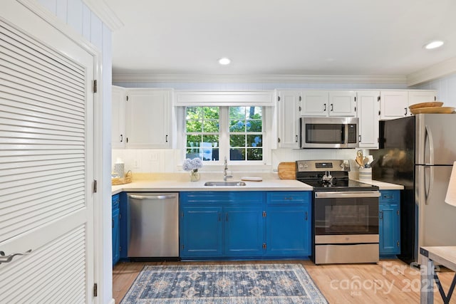 28 Toxaway Pt Unit B7, Lake Toxaway, NC 28747 - kitchen with stainless steel appliances, blue cabinets, white cabinets, light countertops, and light wood finished floors