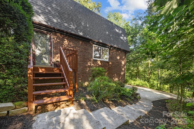 3276 Howard Gap Rd, Hendersonville, NC 28792 - view of home's exterior with roof with shingles, brick siding, and mansard roof