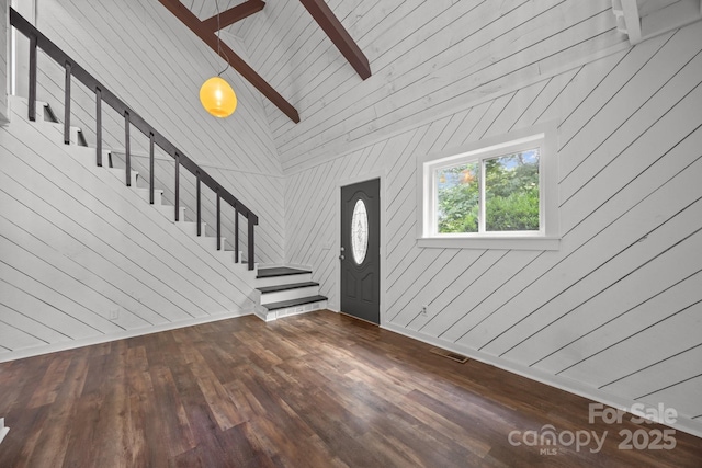 3276 Howard Gap Rd, Hendersonville, NC 28792 - foyer entrance with stairway, dark wood finished floors, ceiling fan, wooden walls, and vaulted ceiling