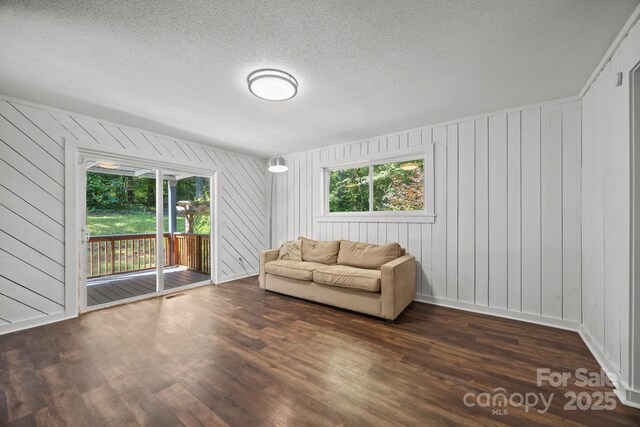 3276 Howard Gap Rd, Hendersonville, NC 28792 - living room with healthy amount of natural light, dark wood-type flooring, and a textured ceiling