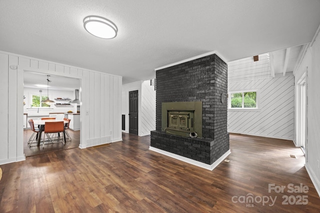 3276 Howard Gap Rd, Hendersonville, NC 28792 - living area with wood finished floors, a brick fireplace, and wooden walls