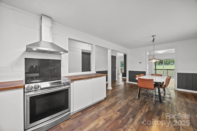 3276 Howard Gap Rd, Hendersonville, NC 28792 - kitchen featuring wall chimney exhaust hood, stainless steel electric range oven, butcher block counters, white cabinetry, and hanging light fixtures