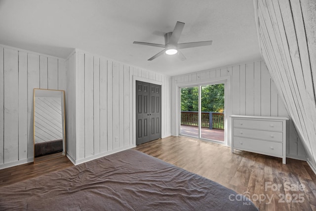 3276 Howard Gap Rd, Hendersonville, NC 28792 - bedroom with access to outside, wood finished floors, wooden walls, and a ceiling fan