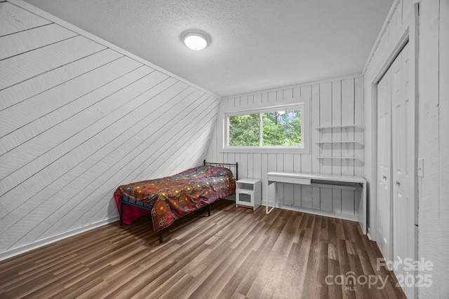 3276 Howard Gap Rd, Hendersonville, NC 28792 - bedroom with wood finished floors and a textured ceiling