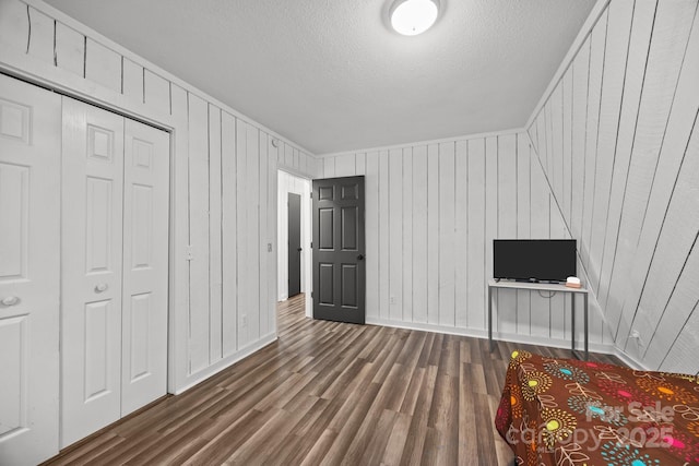 3276 Howard Gap Rd, Hendersonville, NC 28792 - unfurnished bedroom with wood finished floors, a textured ceiling, and a closet