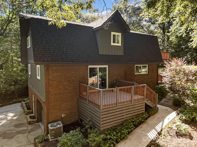 3276 Howard Gap Rd, Hendersonville, NC 28792 - rear view of property with brick siding, roof with shingles, and a deck