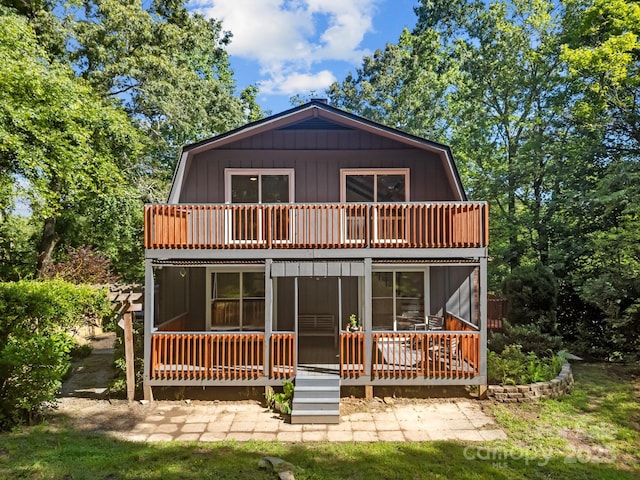 3276 Howard Gap Rd, Hendersonville, NC 28792 - rear view of house with a gambrel roof and a balcony
