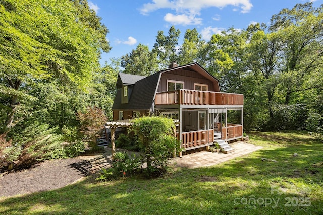 3276 Howard Gap Rd, Hendersonville, NC 28792 - rear view of house featuring a gambrel roof, a chimney, a lawn, and a deck