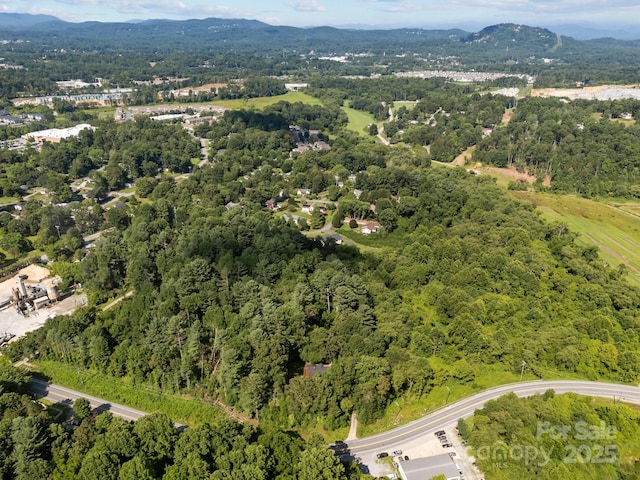 3276 Howard Gap Rd, Hendersonville, NC 28792 - aerial view of property and surrounding area featuring a heavily wooded area and a mountainous background