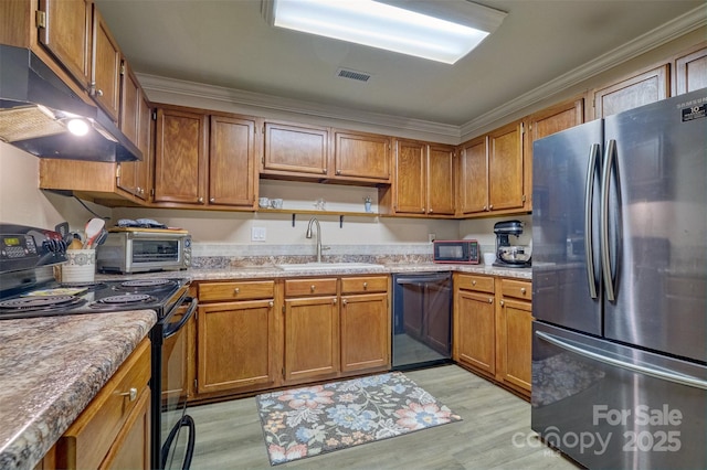 4130 Charlotte Hwy # G, Lake Wylie, SC 29710 - kitchen with black appliances, under cabinet range hood, crown molding, brown cabinetry, and light wood finished floors