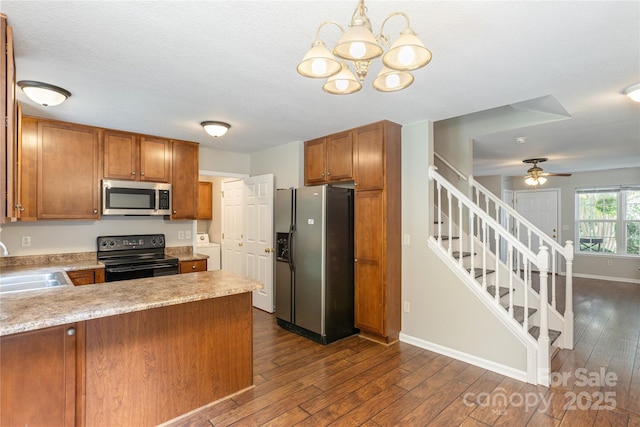256 Farington Cir Unit 128, Fletcher, NC 28732 - kitchen with appliances with stainless steel finishes, washer / dryer, dark wood finished floors, light countertops, and a peninsula