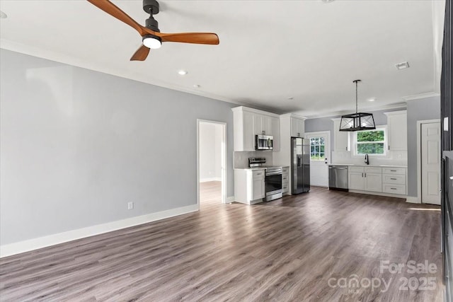 405 E Broad St, Salisbury, NC 28144 - unfurnished living room featuring a ceiling fan, crown molding, wood finished floors, and recessed lighting