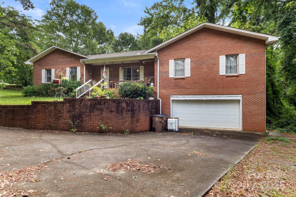 809 E Main St, Shelby, NC 28150 - ranch-style home with driveway, a garage, brick siding, and a porch