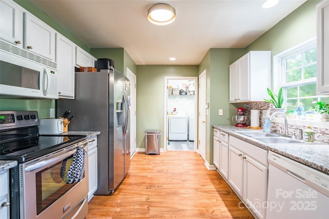 1274 Winding Path Rd, Clover, SC 29710 - kitchen featuring white appliances, washer / dryer, white cabinetry, light wood-style flooring, and recessed lighting
