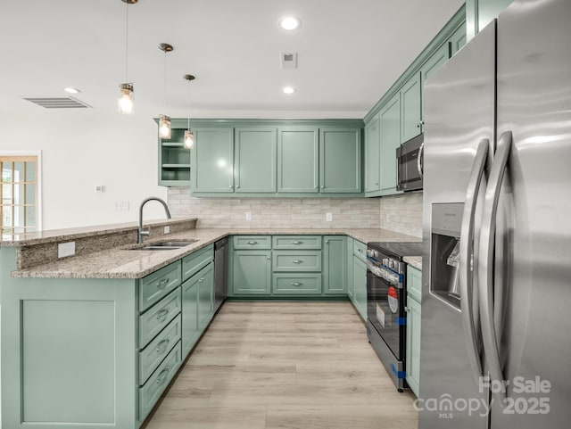 174 Charlie Randall Rd, Lawndale, NC 28090 - kitchen featuring stainless steel appliances, green cabinets, light stone countertops, a peninsula, and pendant lighting