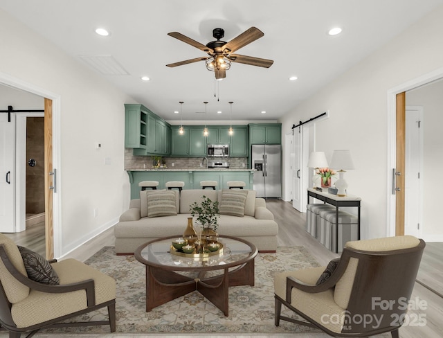 174 Charlie Randall Rd, Lawndale, NC 28090 - living room with a barn door, a ceiling fan, light wood-type flooring, and recessed lighting