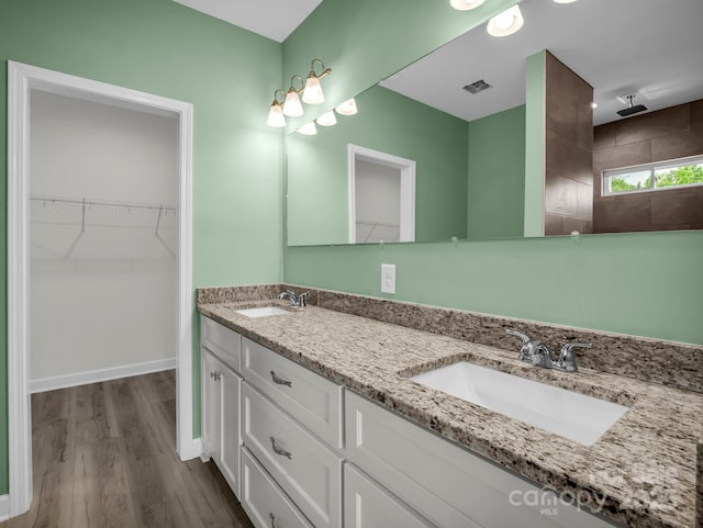 174 Charlie Randall Rd, Lawndale, NC 28090 - full bath with double vanity, wood finished floors, a walk in closet, and a tile shower