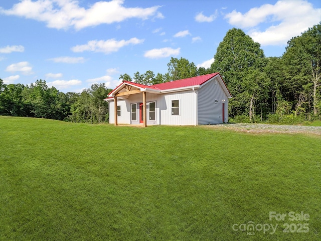 174 Charlie Randall Rd, Lawndale, NC 28090 - view of front of property with a front yard, an attached garage, a metal roof, gravel driveway, and board and batten siding
