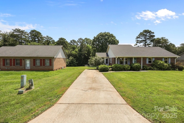 416 Park Ave, Granite Quarry, NC 28072 - view of front facade with driveway, brick siding, and a front lawn