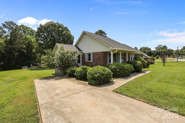 416 Park Ave, Granite Quarry, NC 28072 - view of home's exterior with a lawn and brick siding