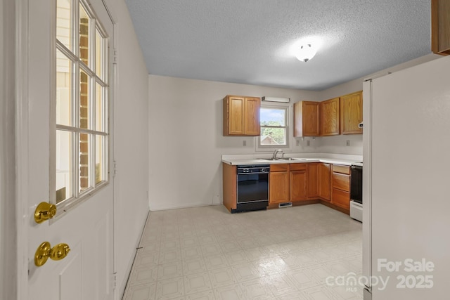 416 Park Ave, Granite Quarry, NC 28072 - kitchen with dishwasher, freestanding refrigerator, light countertops, a textured ceiling, and range