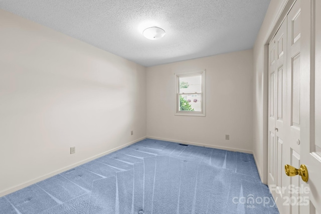 416 Park Ave, Granite Quarry, NC 28072 - unfurnished bedroom with a textured ceiling, carpet flooring, and a closet
