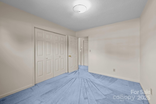 416 Park Ave, Granite Quarry, NC 28072 - unfurnished bedroom with a textured ceiling, carpet flooring, and a closet