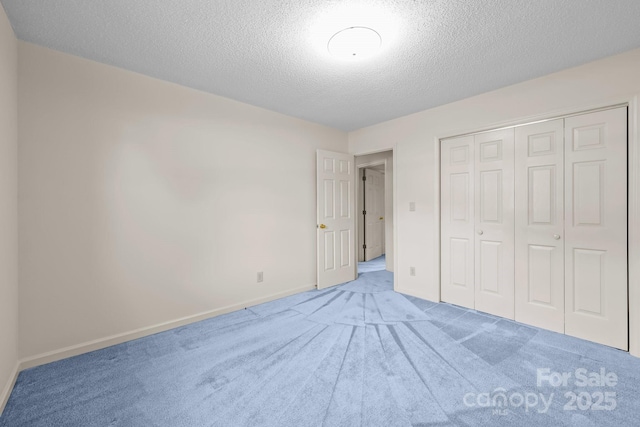 416 Park Ave, Granite Quarry, NC 28072 - unfurnished bedroom featuring carpet, a textured ceiling, and a closet