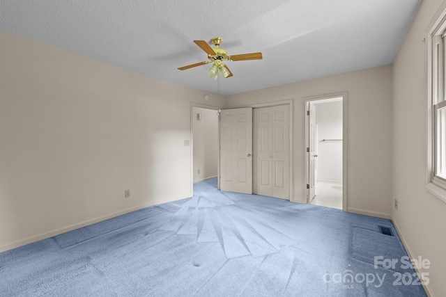 416 Park Ave, Granite Quarry, NC 28072 - unfurnished bedroom with carpet floors, ensuite bath, ceiling fan, a textured ceiling, and a closet